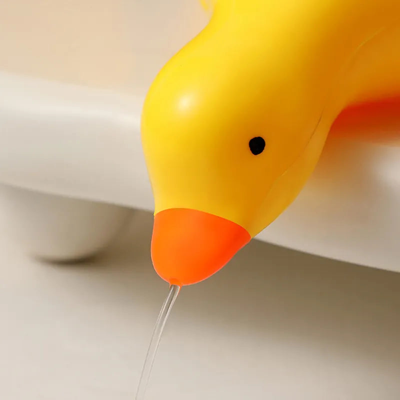 A duck-shaped soap tray with orange feet and a yellow body by TradePro Solutions.